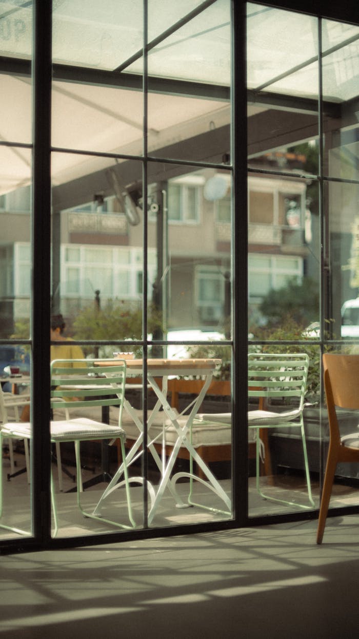 Bright terrace seating area of a café in İstanbul showing modern chairs and tables.